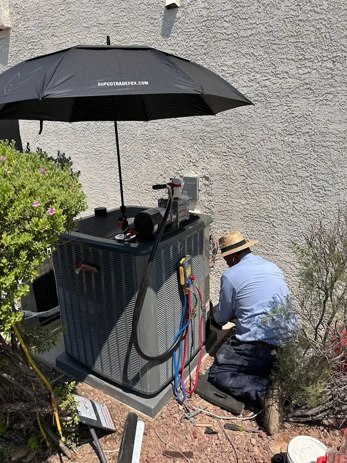 HVAC technician performing outdoor AC maintenance in East Buffalo